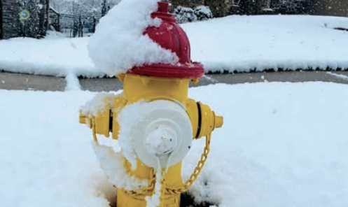 Fire hydrant surrounded by snow